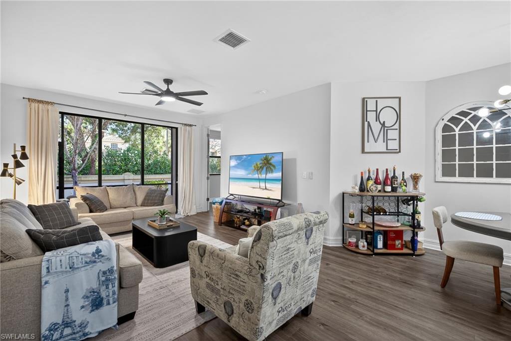 7845 Bristol Circle Naples, FL 34120 - Photo 5 of 31 a living room with furniture and a large window