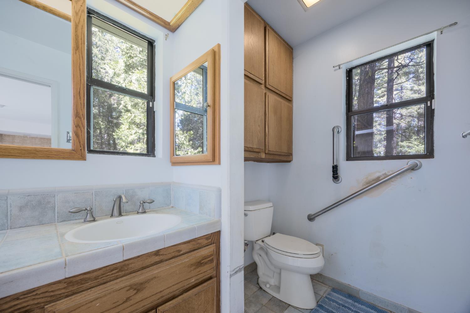 2070 King Of The Mountain Road Pollock Pines, CA 95726 - Photo 16 of 53 a bathroom with a sink a toilet and window