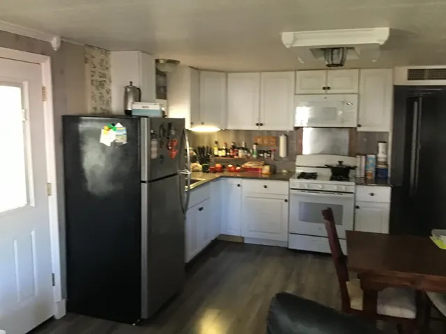 a kitchen with a refrigerator a stove a sink dishwasher and a refrigerator