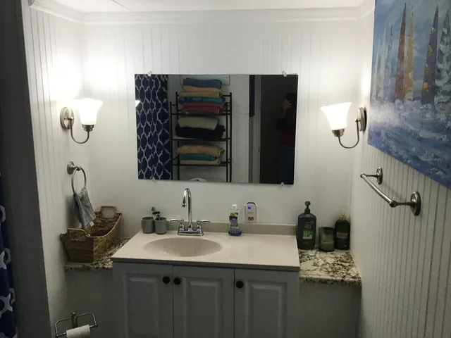 a bed sitting in a bedroom next to a lamp