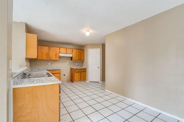 a kitchen with stainless steel appliances granite countertop a sink refrigerator and cabinets