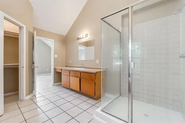 a bathroom with a granite countertop sink mirror and shower