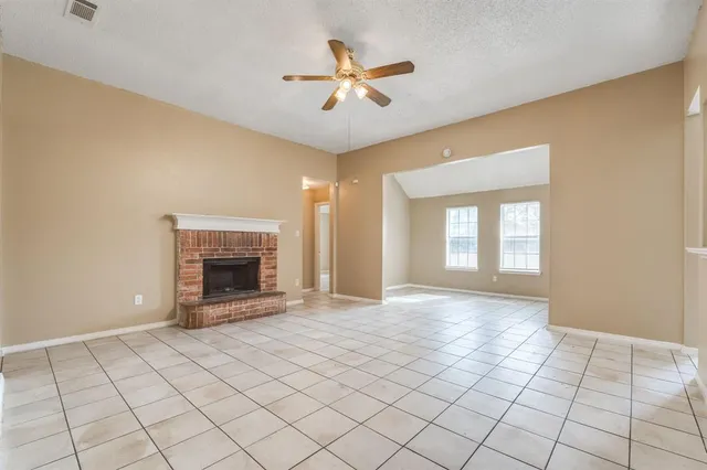 a view of an empty room and fire place