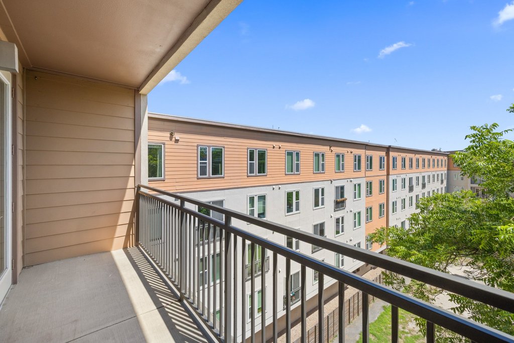 1900 Barton Springs Road, Unit 5009 Austin, TX 78704 - Photo 16 of 35 A private balcony offers elevated neighborhood views under a clear sky.