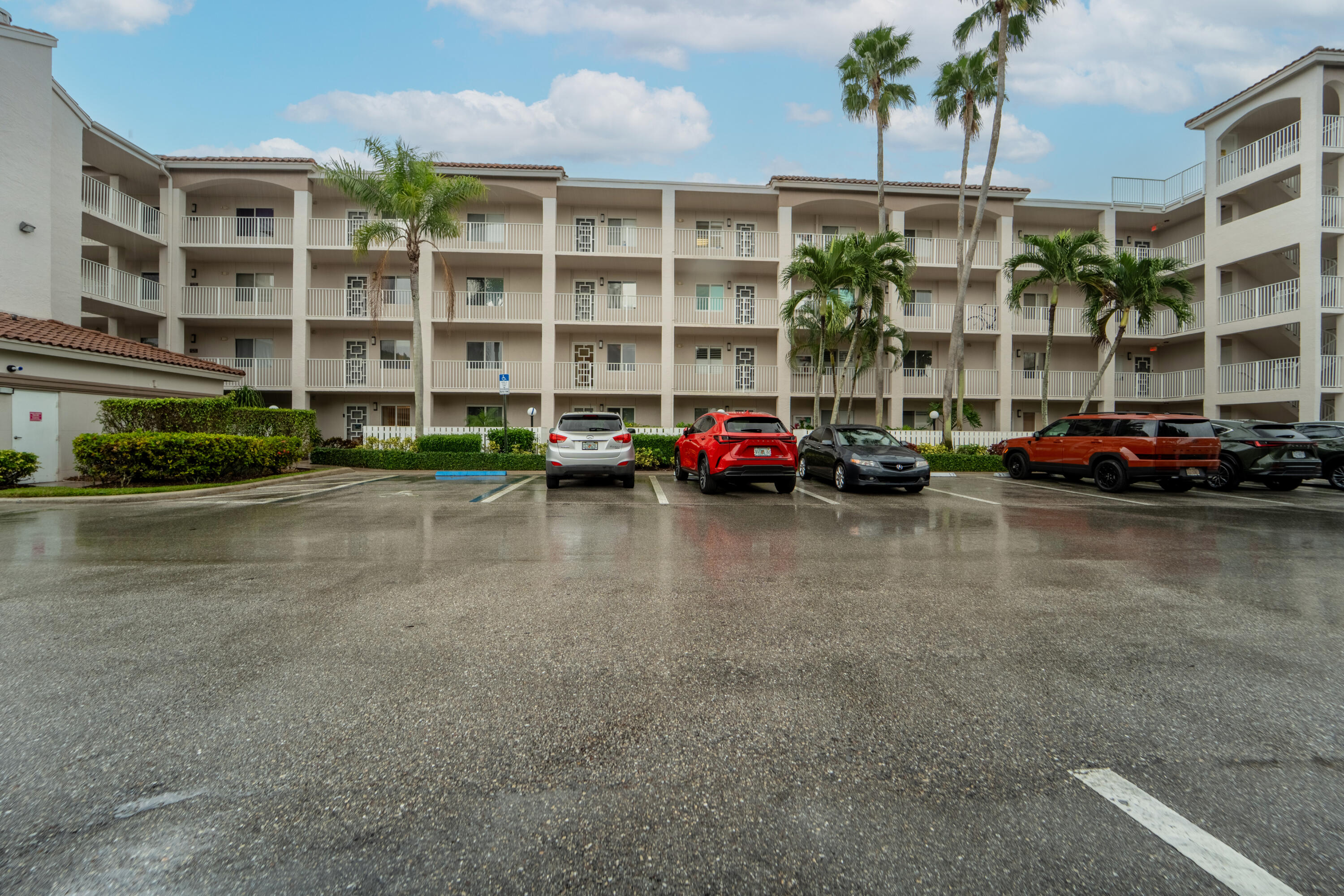 14112 Huntington Pointe Drive, Unit 309 Delray Beach, FL 33484 - Photo 1 of 50 a cars parked in front of a building