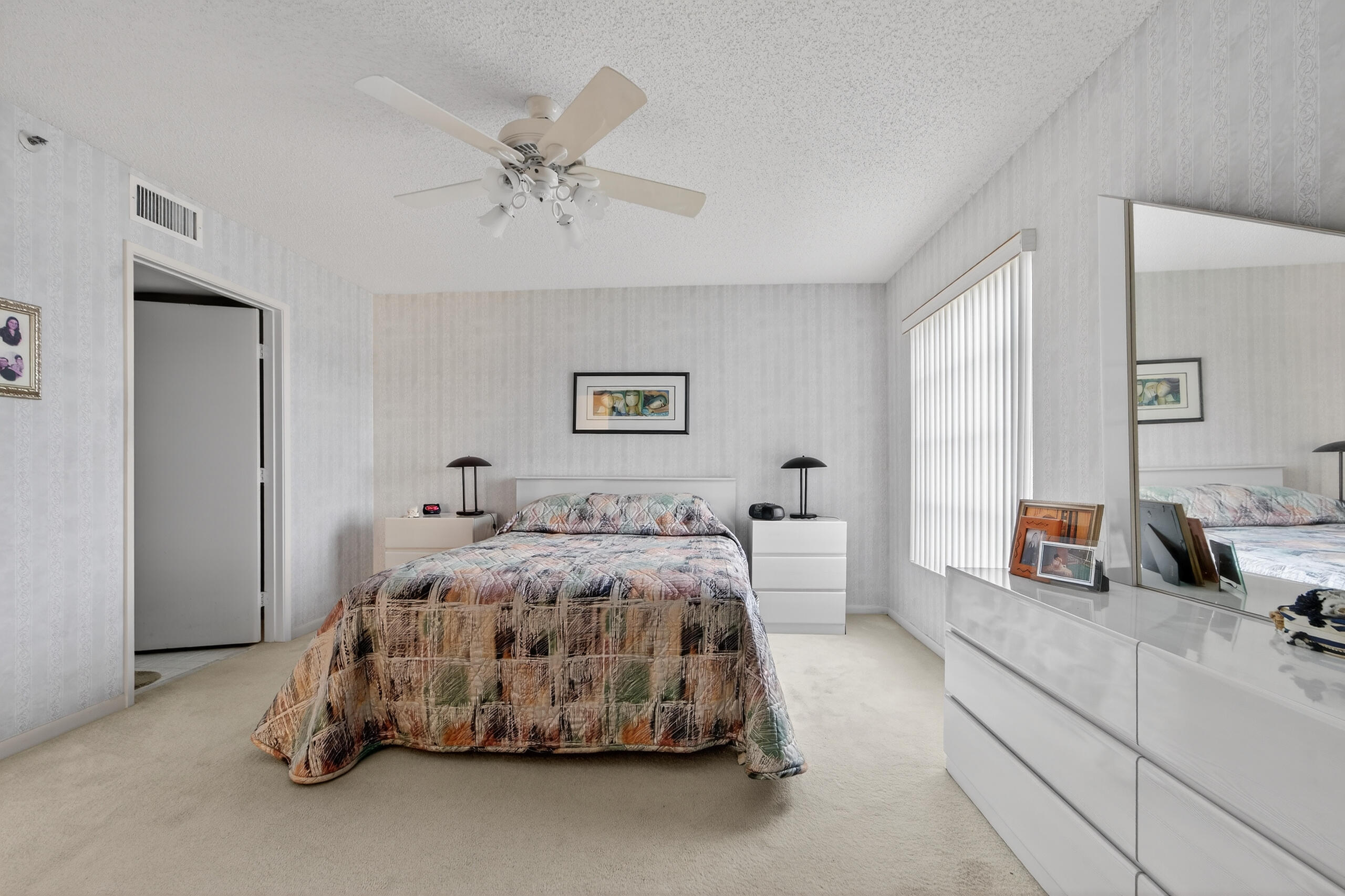 14112 Huntington Pointe Drive, Unit 309 Delray Beach, FL 33484 - Photo 16 of 50 a bedroom with a bed and ceiling fan