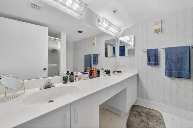 a bathroom with a double vanity sink mirror and