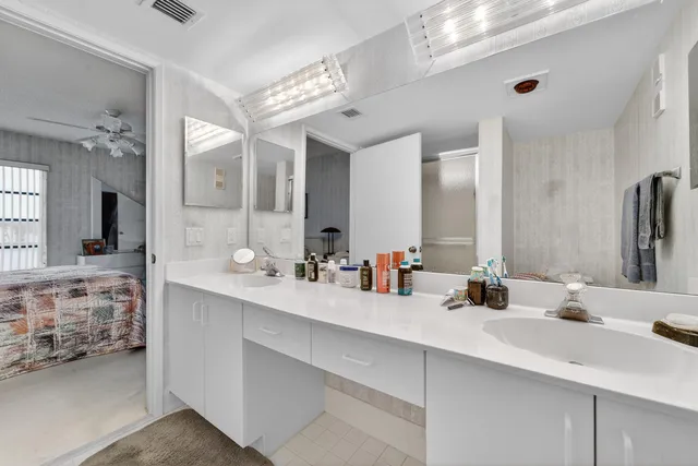 a bathroom with double vanity sinks and a mirror