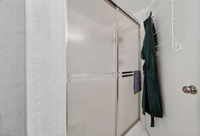 a bathroom with a shower and a mirror