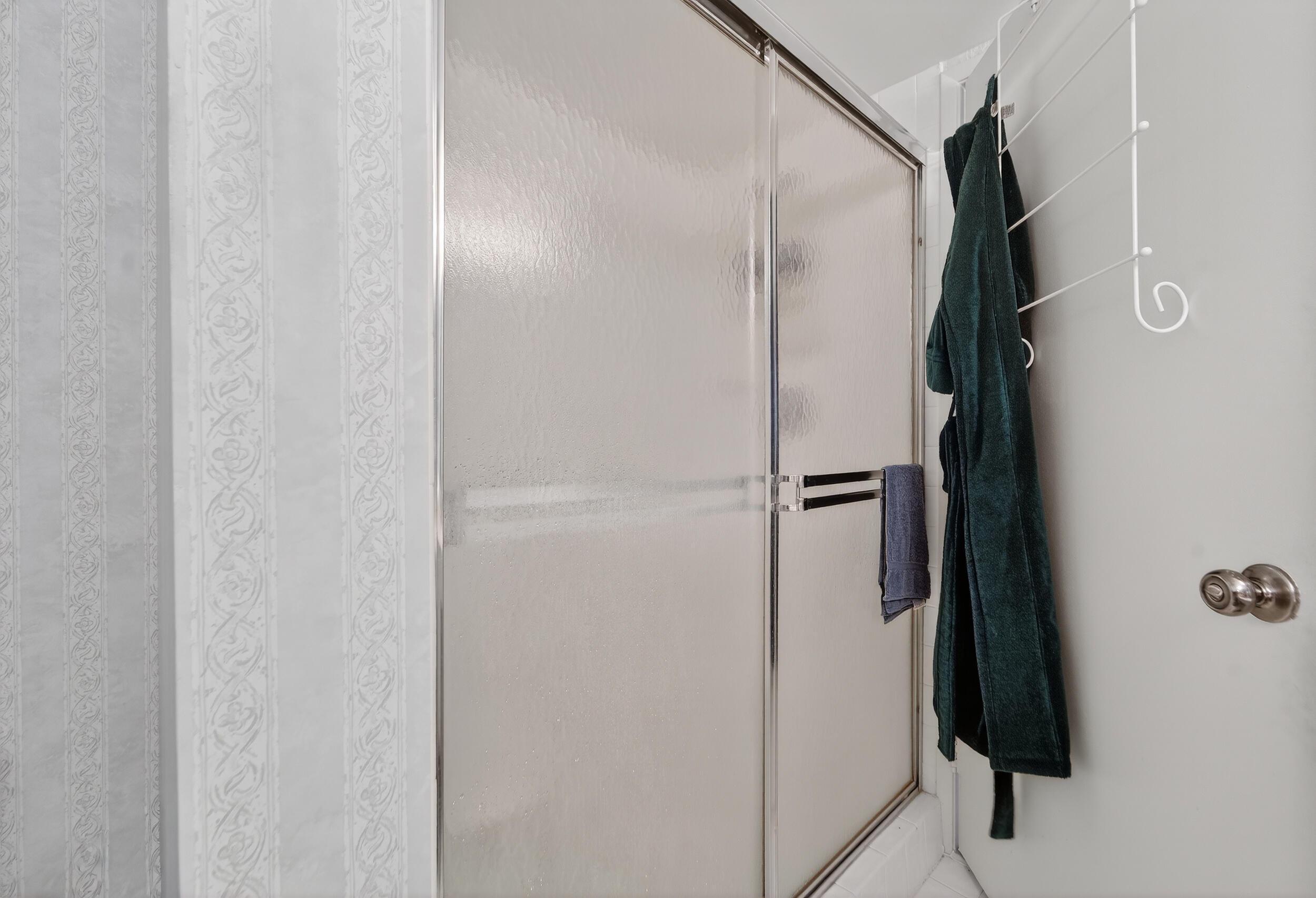 14112 Huntington Pointe Drive, Unit 309 Delray Beach, FL 33484 - Photo 19 of 50 a bathroom with a shower and a mirror