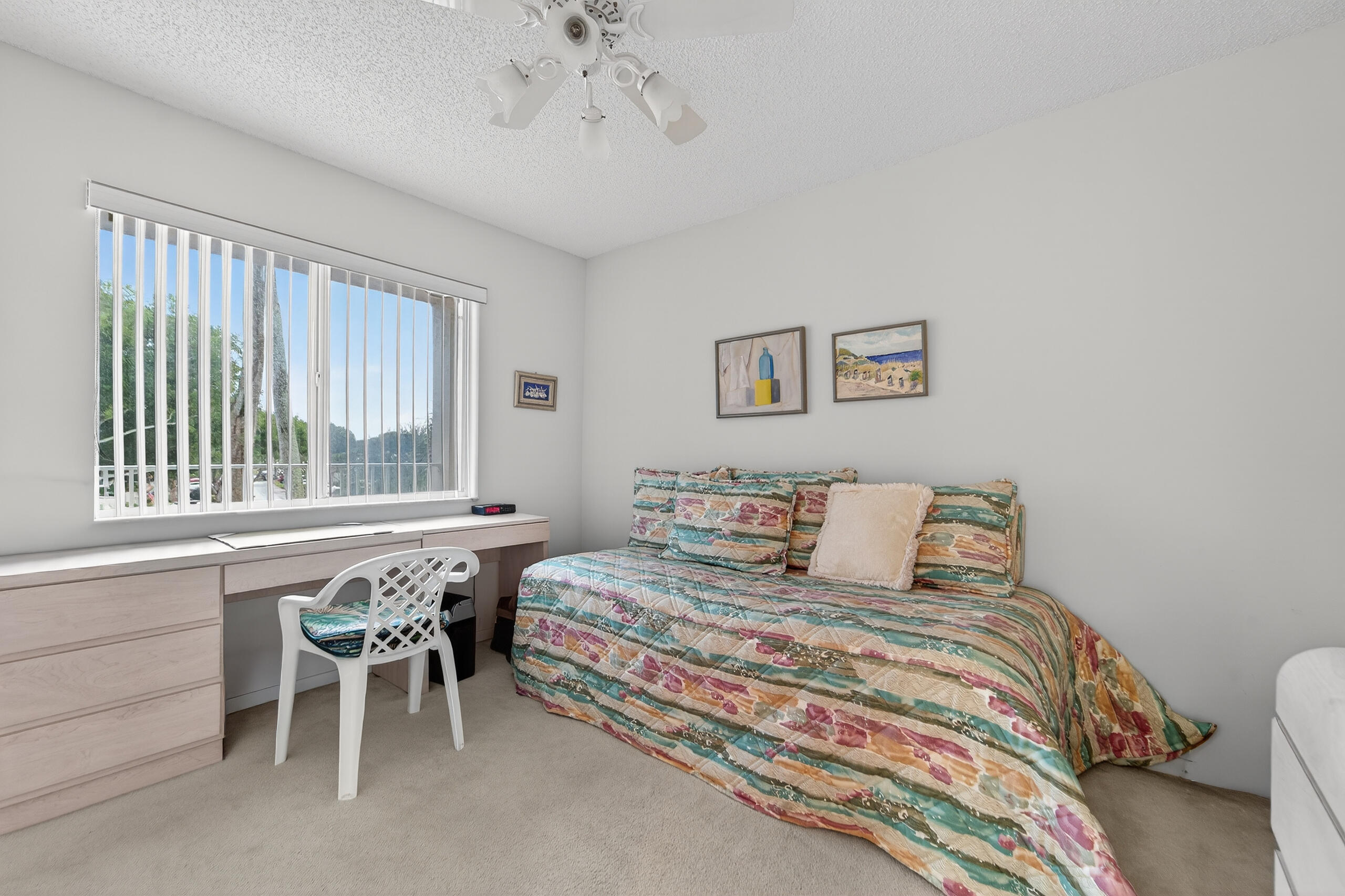 14112 Huntington Pointe Drive, Unit 309 Delray Beach, FL 33484 - Photo 21 of 50 a bedroom with a bed and a table