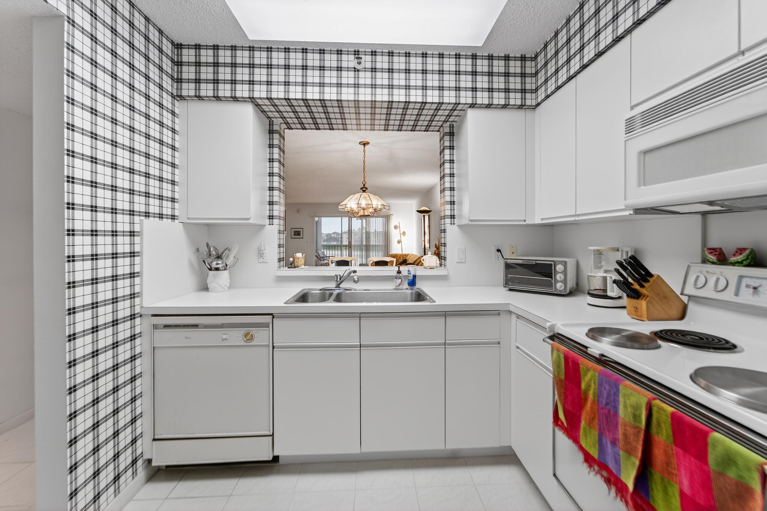 14112 Huntington Pointe Drive, Unit 309 Delray Beach, FL 33484 - Photo 4 of 50 a kitchen with a sink cabinets and appliances