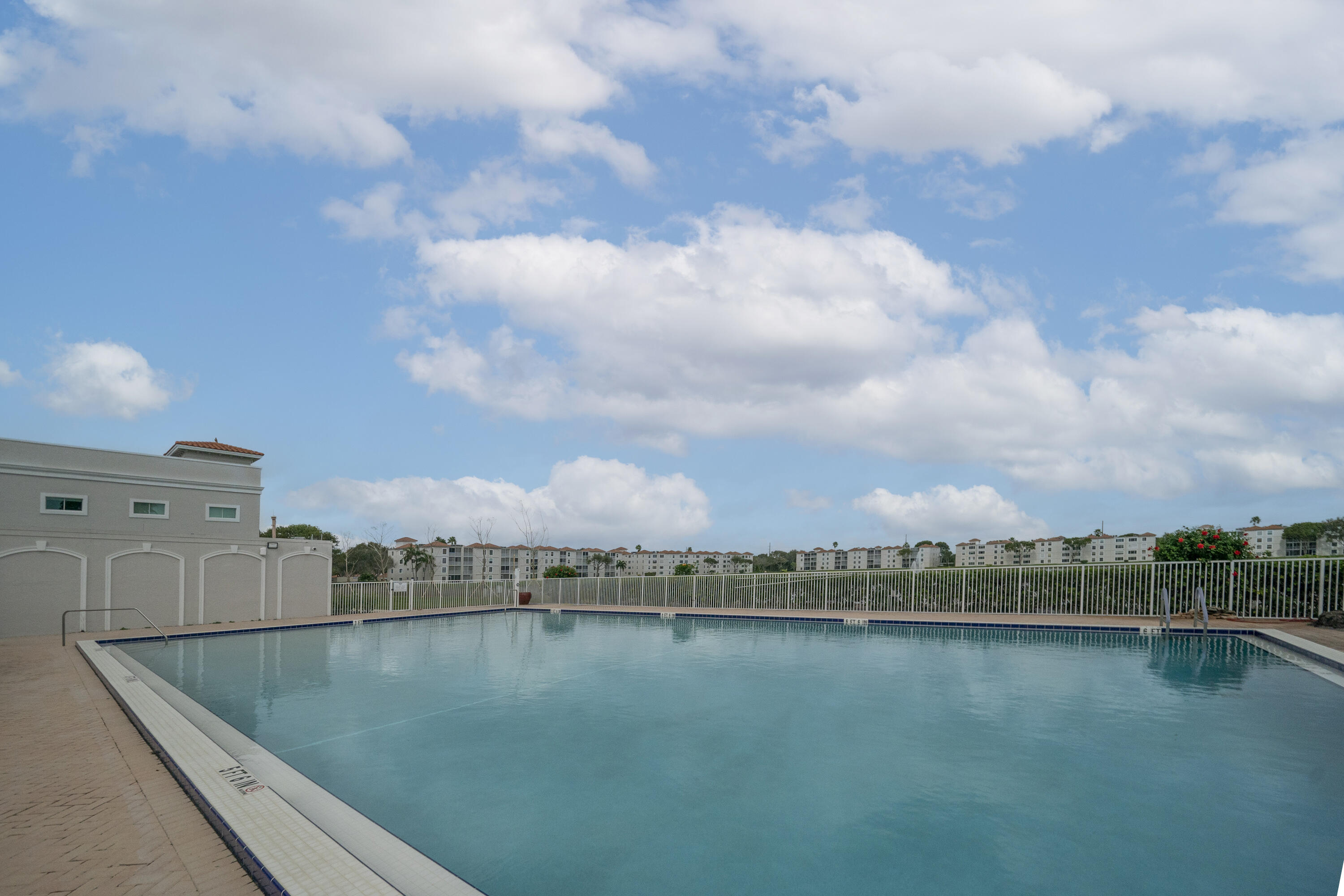 14112 Huntington Pointe Drive, Unit 309 Delray Beach, FL 33484 - Photo 42 of 50 a view of a swimming pool and lake view