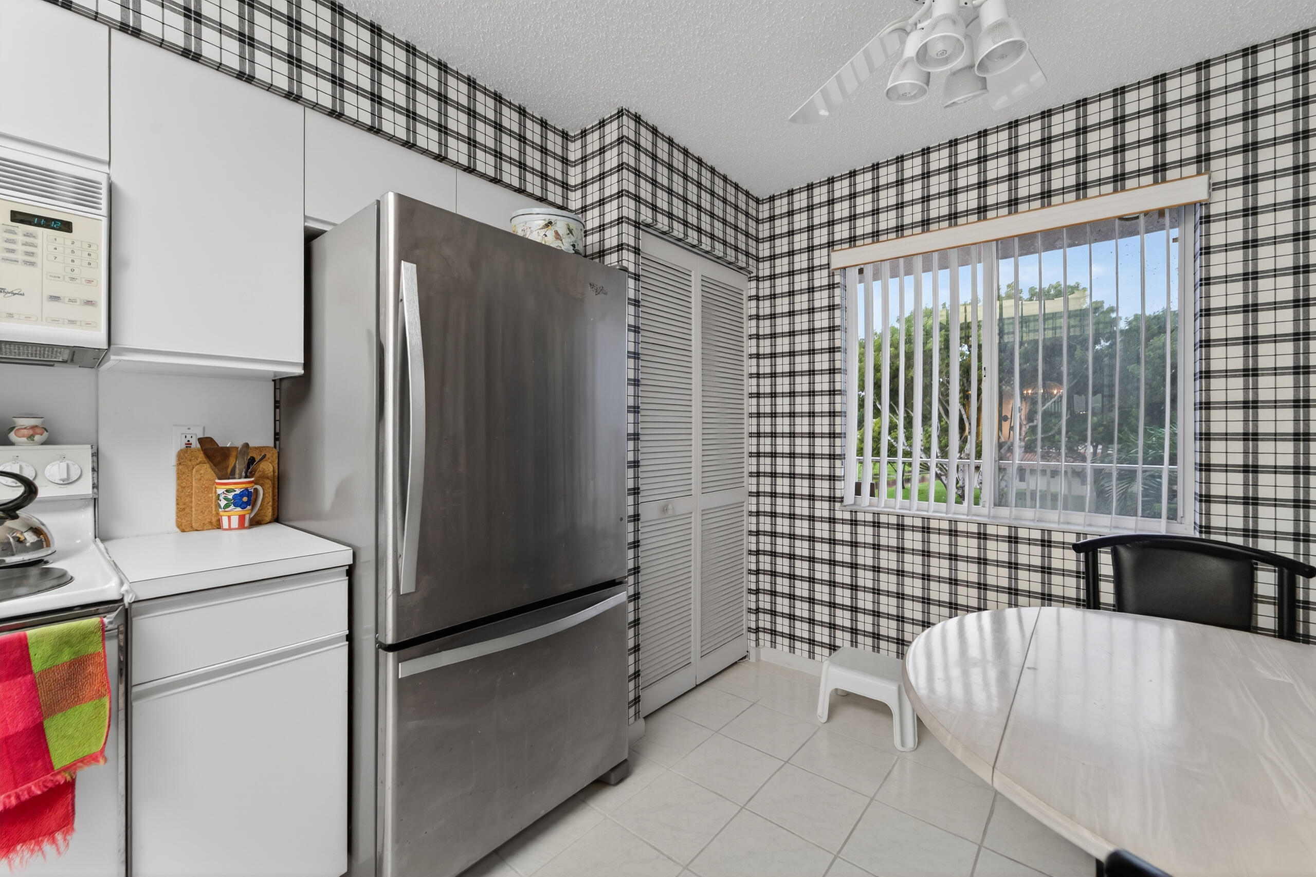 14112 Huntington Pointe Drive, Unit 309 Delray Beach, FL 33484 - Photo 7 of 50 a kitchen with a refrigerator and a sink