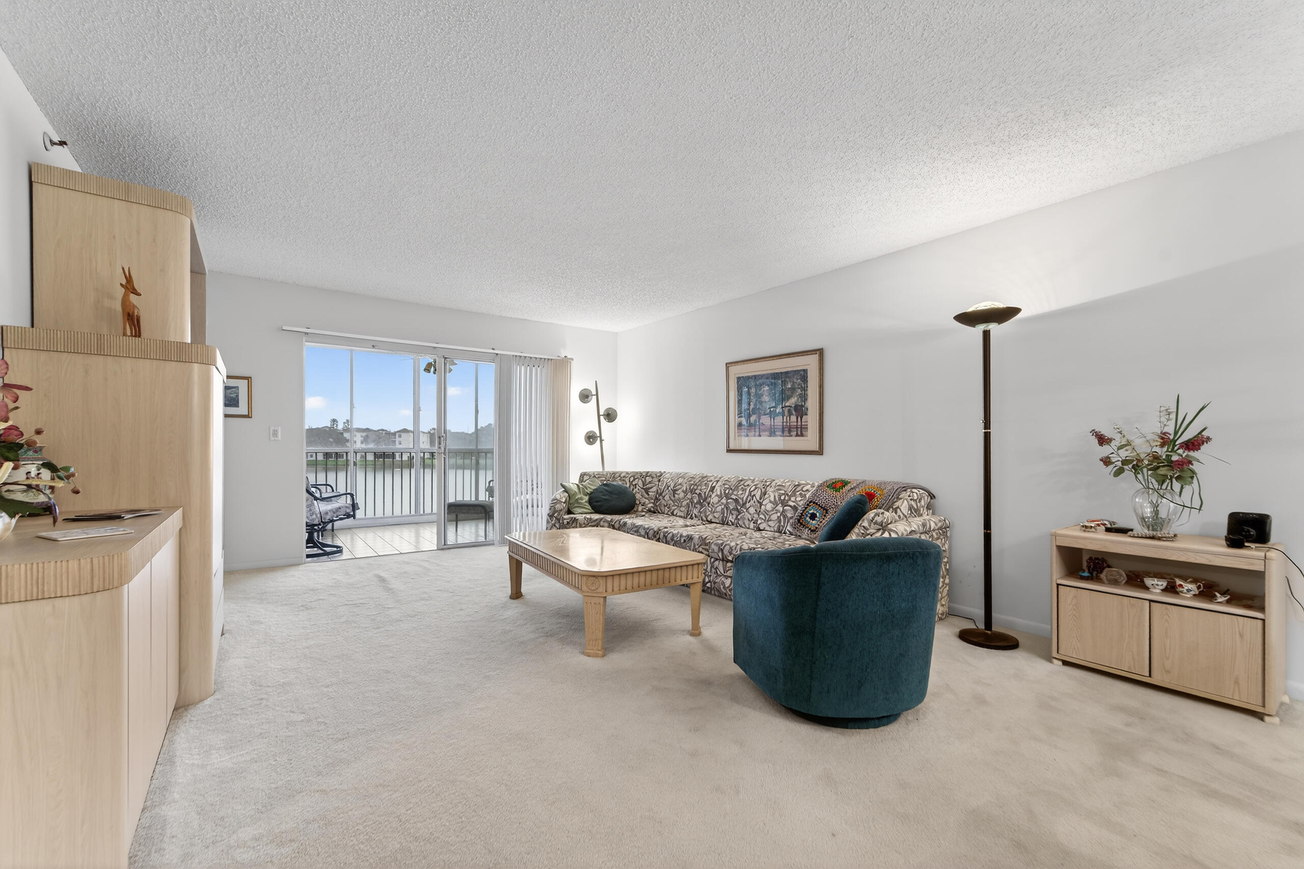 14112 Huntington Pointe Drive, Unit 309 Delray Beach, FL 33484 - Photo 8 of 50 a living room with a couch and a stove top oven