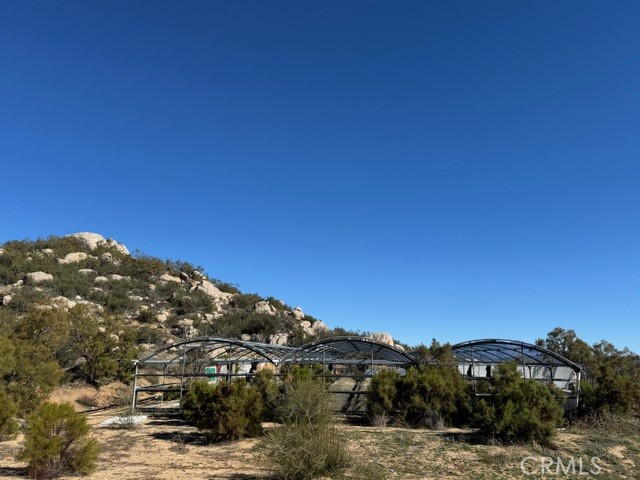 54740 Cave Rock Road Anza, CA 92539 - Photo 8 of 47 a view of a large building with a tree in the background