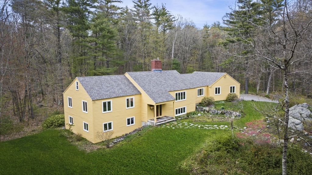 46 Georgetown Road Boxford, MA 01921 - Photo 1 of 40 a aerial view of a house with yard and trees in the background