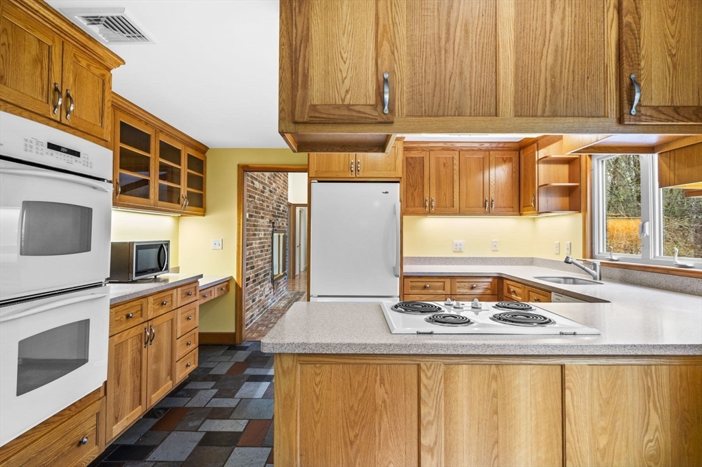 46 Georgetown Road Boxford, MA 01921 - Photo 13 of 40 a kitchen with stainless steel appliances a stove and a refrigerator