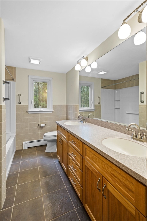 46 Georgetown Road Boxford, MA 01921 - Photo 23 of 40 a spacious bathroom with a double vanity sink a large mirror and a bathtub
