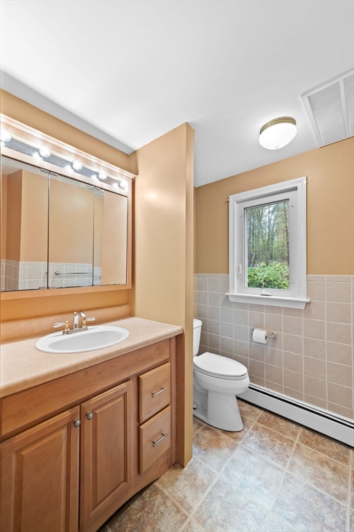 46 Georgetown Road Boxford, MA 01921 - Photo 30 of 40 a bathroom with a sink a toilet and a window