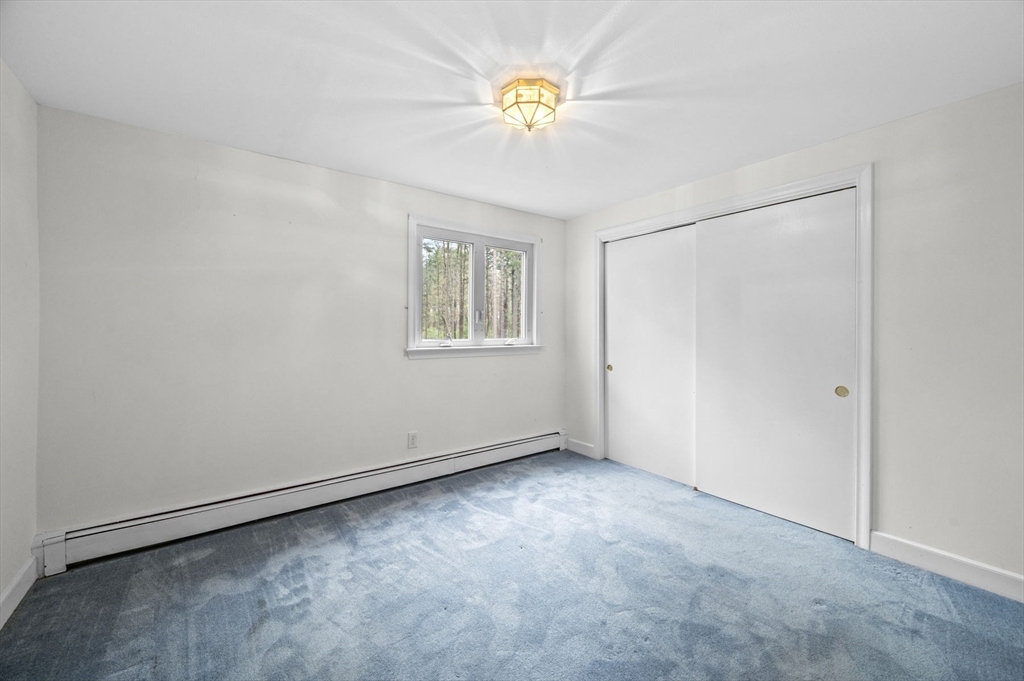 46 Georgetown Road Boxford, MA 01921 - Photo 31 of 40 an empty room with windows and closet
