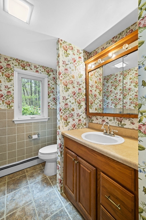 46 Georgetown Road Boxford, MA 01921 - Photo 35 of 40 a bathroom with a sink a toilet and a window