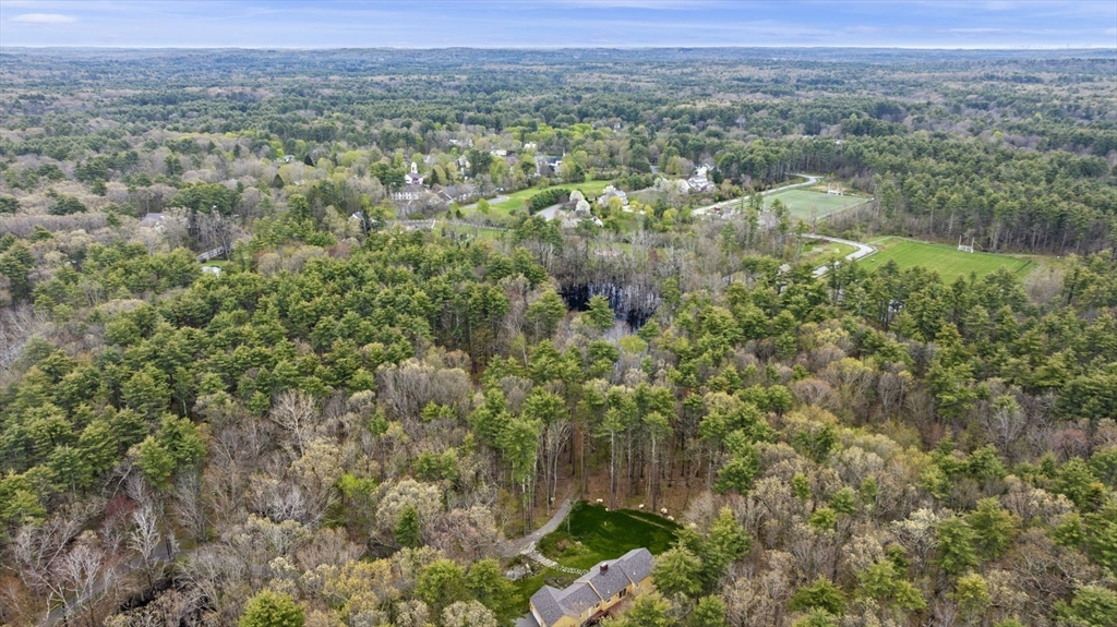 46 Georgetown Road Boxford, MA 01921 - Photo 9 of 40 a view of a lush green forest with trees and some houses