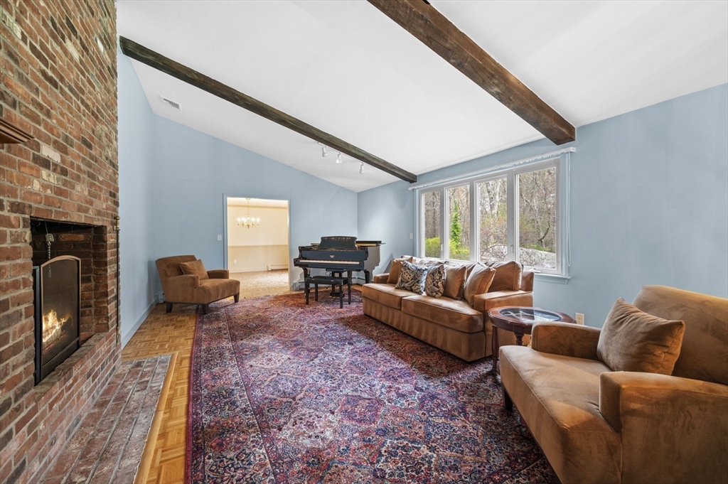46 Georgetown Road Boxford, MA 01921 - Photo 10 of 40 a living room with furniture a fireplace and a flat screen tv