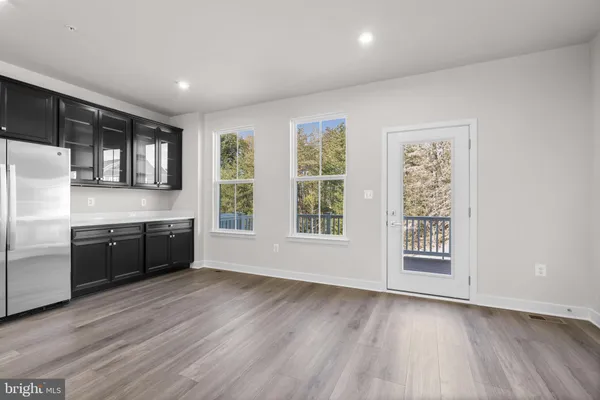 a large kitchen with stainless steel appliances granite countertop a stove a sink dishwasher a microwave oven with cabinets and wooden floor