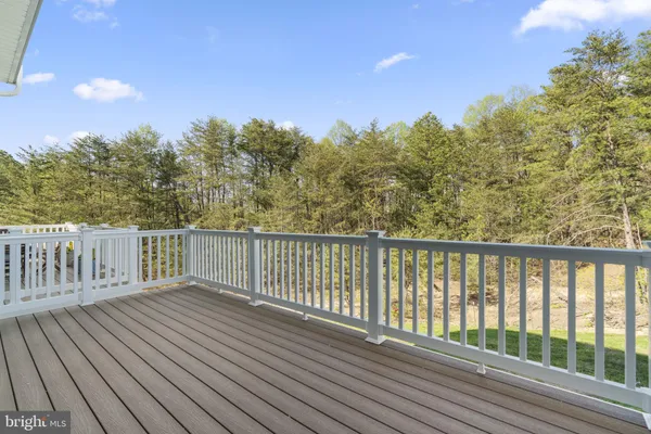 a balcony with wooden floor and fence