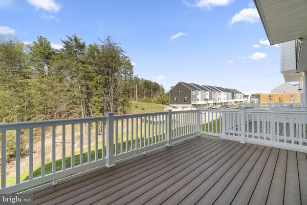 a view of balcony with wooden floor and fence