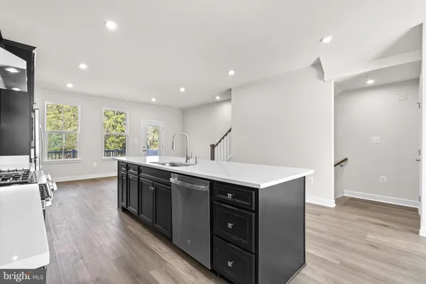 a kitchen with a sink and wooden cabinets
