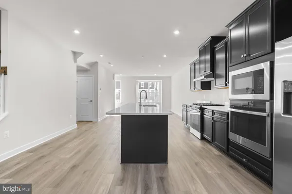 a kitchen with stainless steel appliances granite countertop a stove and a refrigerator