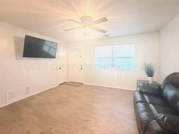 a view of livingroom with furniture window and a ceiling fan