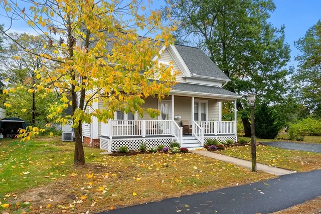 a front view of a house with a yard table and chairs
