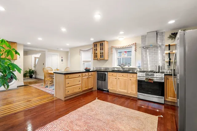 a kitchen with stainless steel appliances granite countertop a refrigerator and a sink