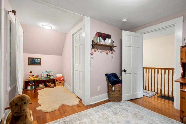 a view of hallway with wooden floor