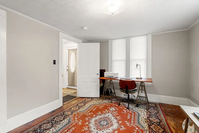 a view of a building with a garden and pathway