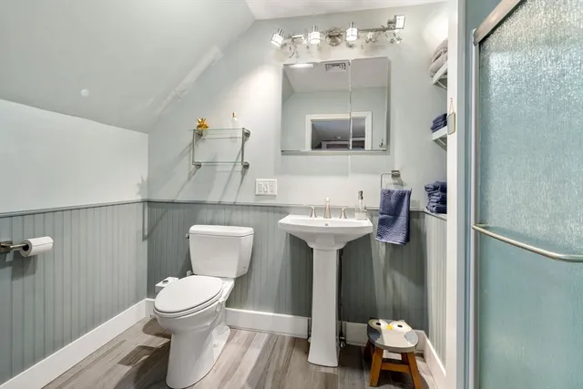 a view of a white house with a swimming pool table and chairs