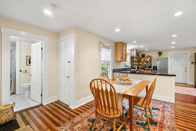 a dining room with furniture and wooden floor