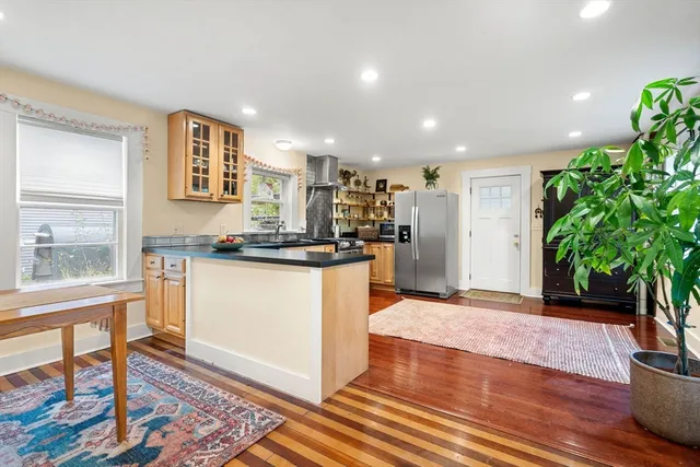 a kitchen with stainless steel appliances granite countertop a refrigerator sink and stove