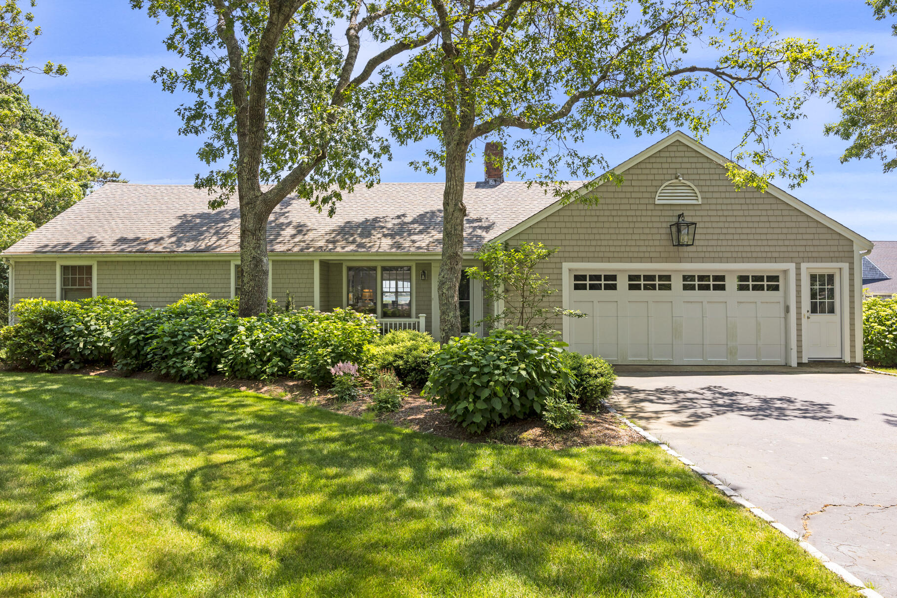 28 Bayview Road Osterville, MA 02655 - Photo 3 of 42 a front view of a house with a yard and garage