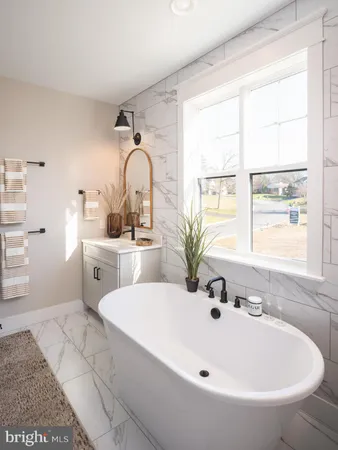 a white bath tub sitting next to a white sink