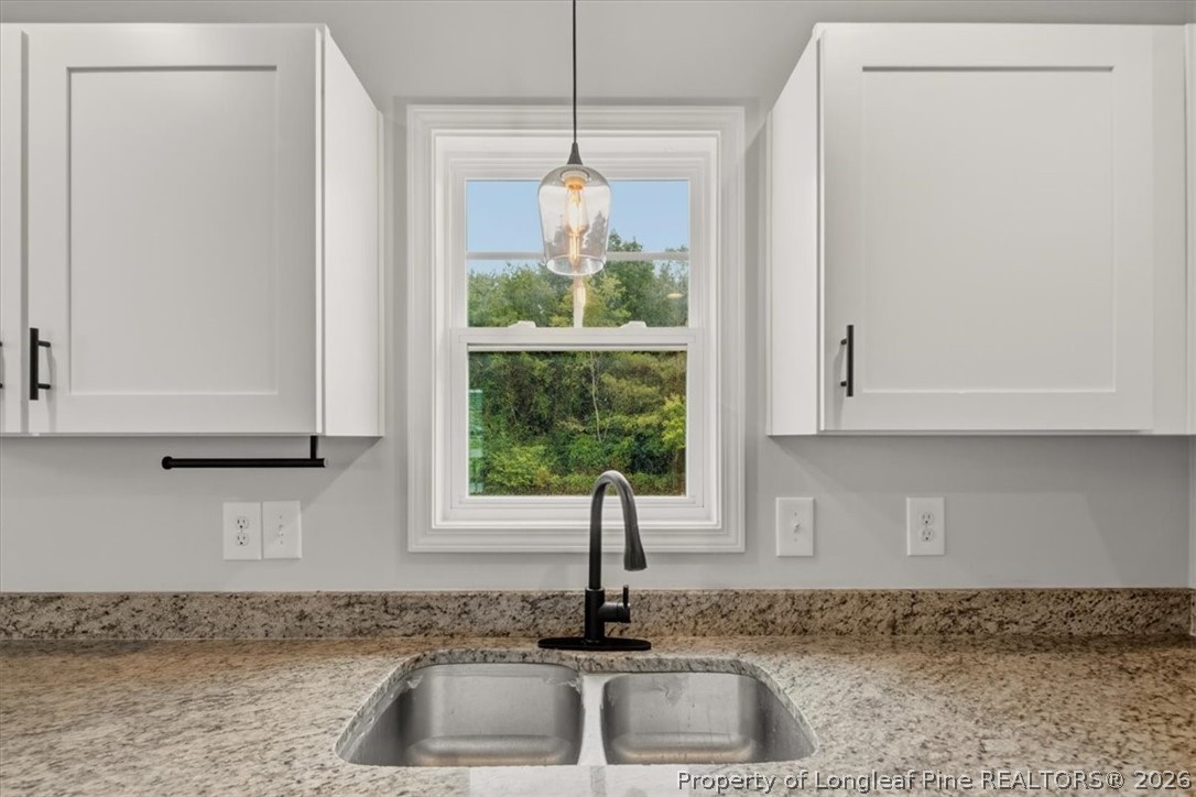 170 Starlight Road Lillington, NC 27546 - Photo 17 of 37 a kitchen with granite countertop a sink and a window