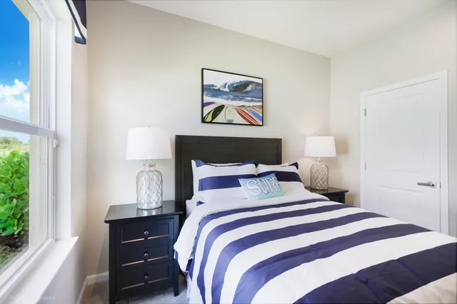 a bedroom with a bed and a window