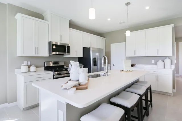 a kitchen with a sink stove and microwave