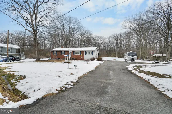 a view of a house with snow in the yard
