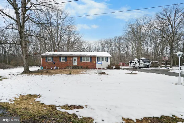 a view of a house with a yard covered in snow