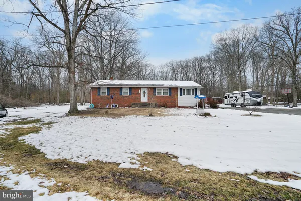 a backyard of a house with fire pit and trees