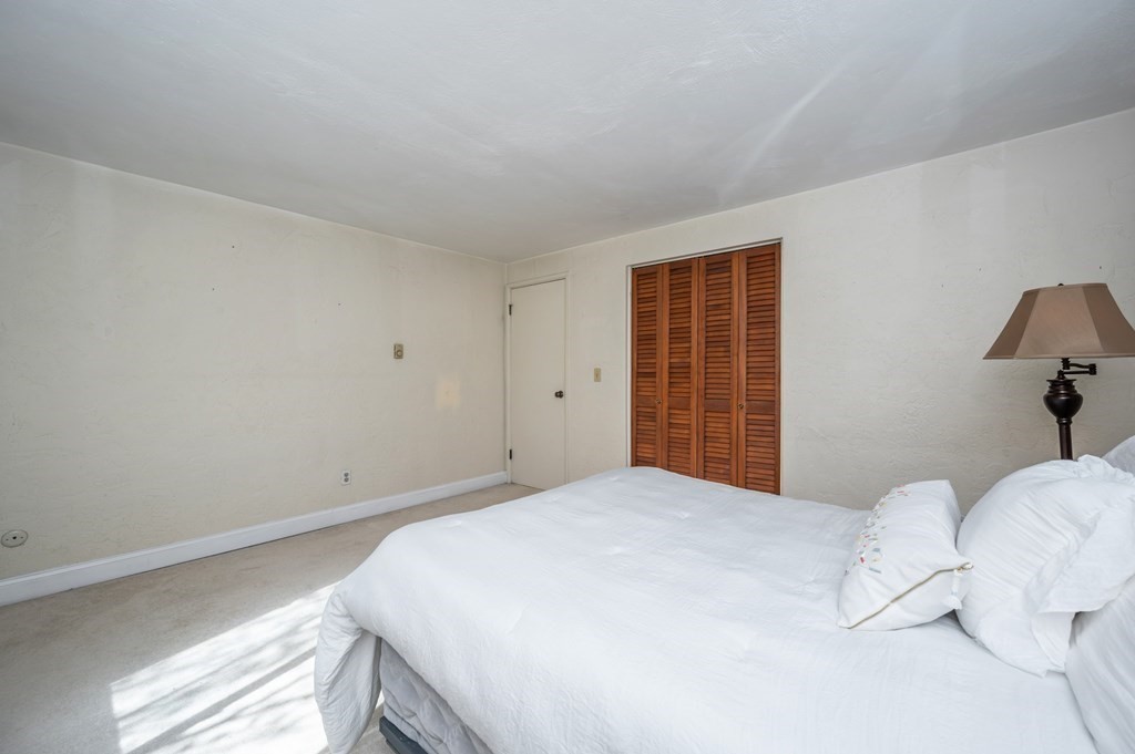 300 Swanson Road, Unit 218 Boxborough, MA 01719 - Photo 14 of 23 a bedroom with a bed and a window